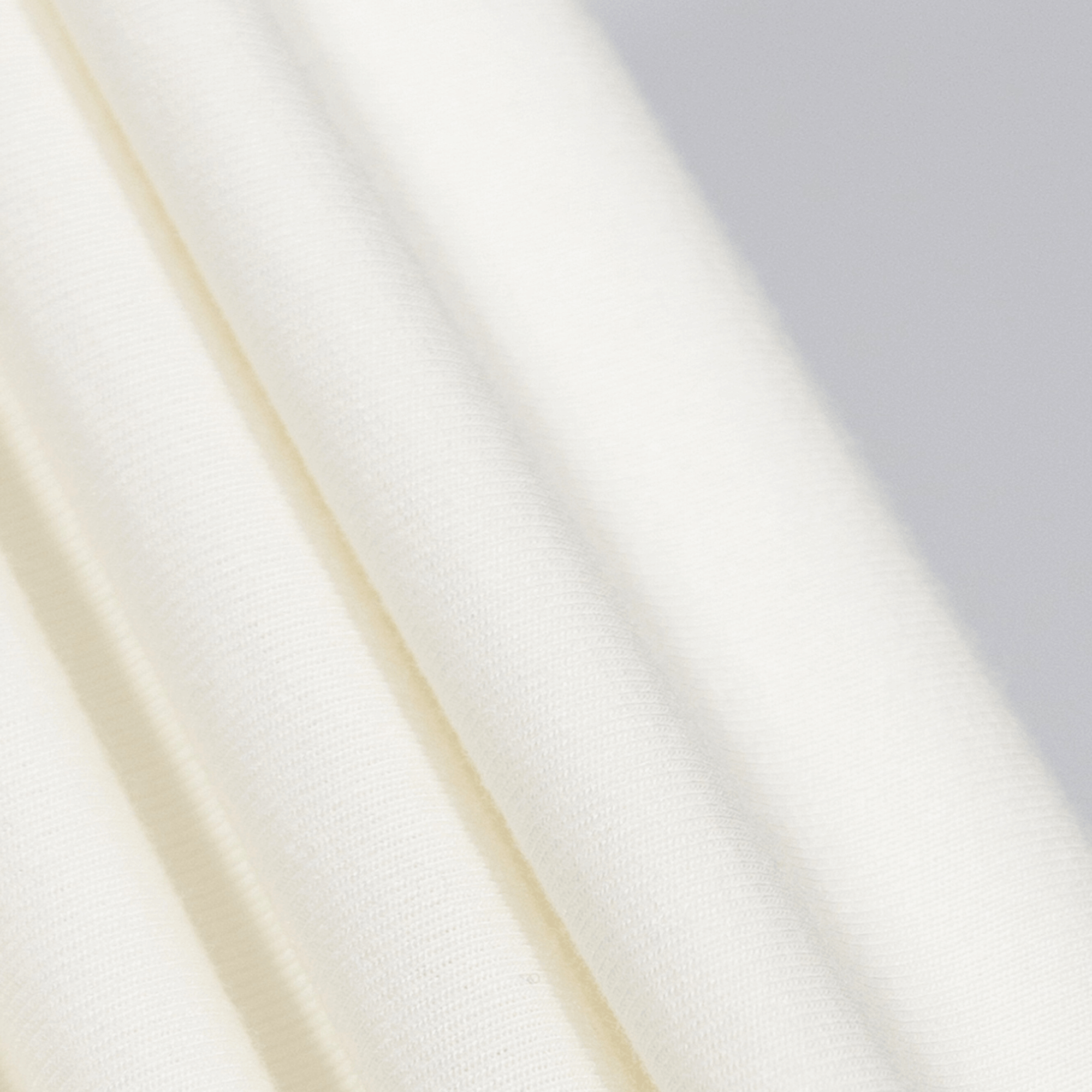 Close-up of soft white HY-Blend fabric showcasing premium texture and stretch for Block Logo Crew Tee