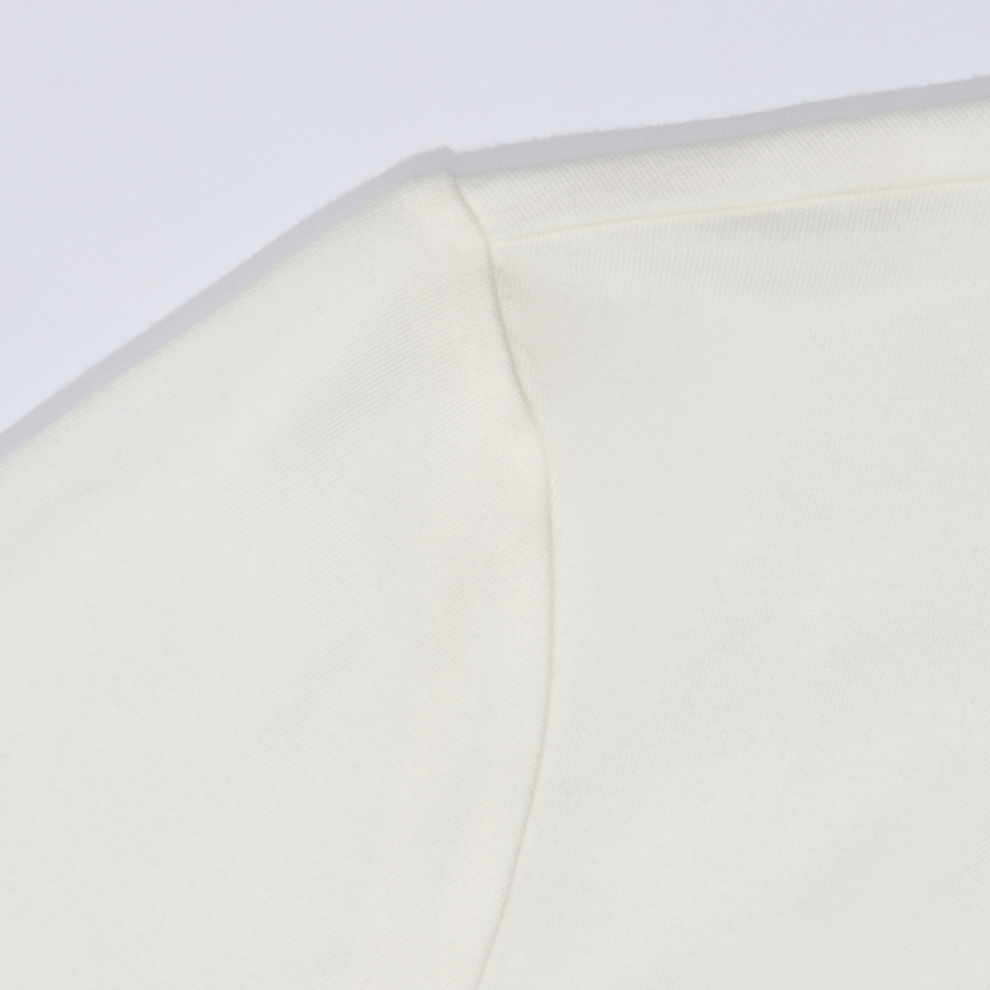 Close-up of white Block Logo HY-Blend Crew Tee showcasing its premium fabric and seamless design for versatile athletes.