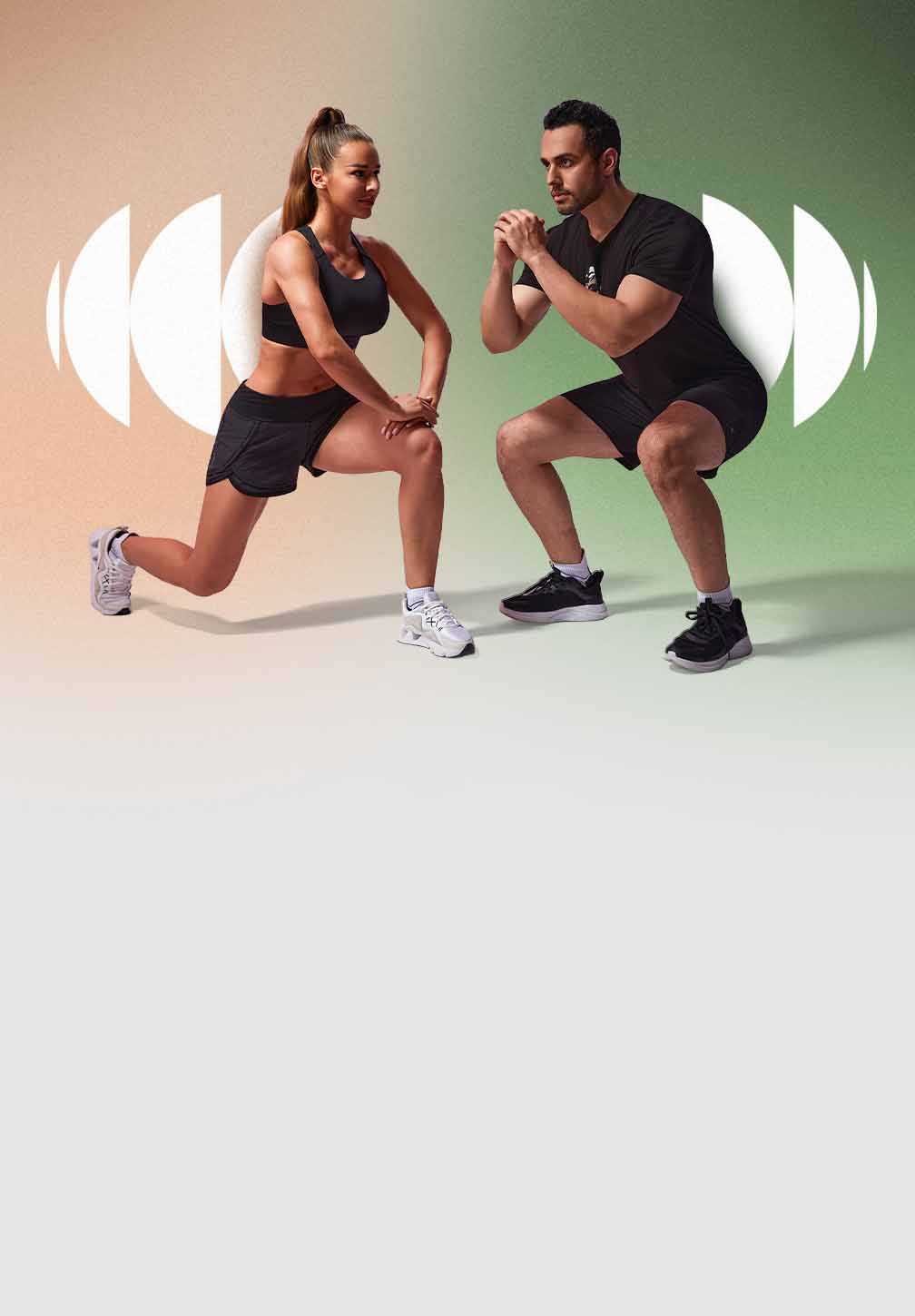 A man and woman, both wearing Hylete athletic gear, perform a lunge and a squat side-by-side.