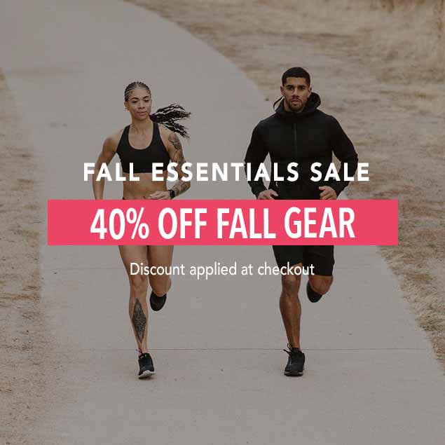 A man and a woman in Hylete athletic apparel running on a paved path, advertising a 'FALL ESSENTIALS SALE' with '40% OFF FALL GEAR.'