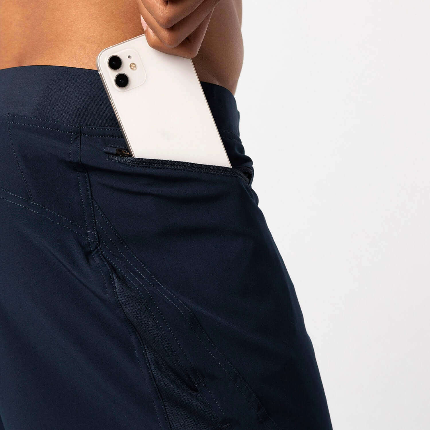 Close-up of navy incline lined shorts with a phone in the roomy right-hand pocket, perfect for workouts.