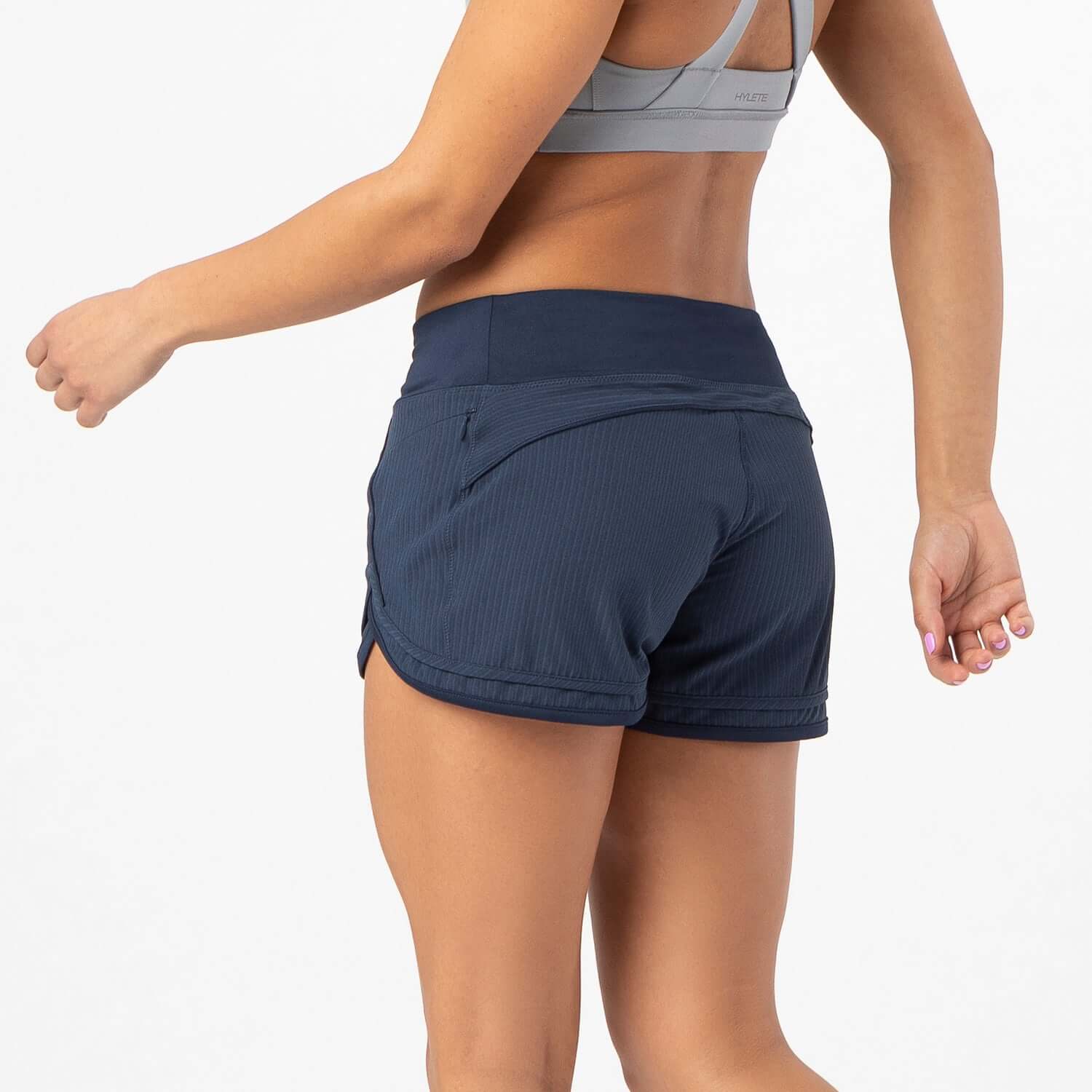 Woman wearing Iris Lined Short Classic Navy, showcasing the Flex-Knit waistband and breathable mesh liner for comfort.