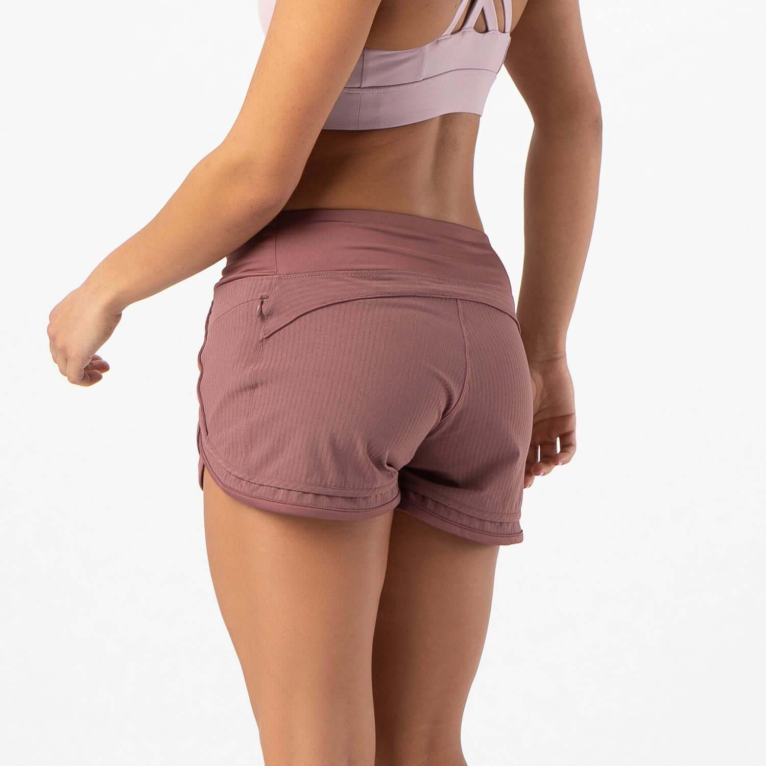 Woman wearing Iris Lined Short in mauve brown, showcasing the Flex-Knit waistband and breathable mesh liner.