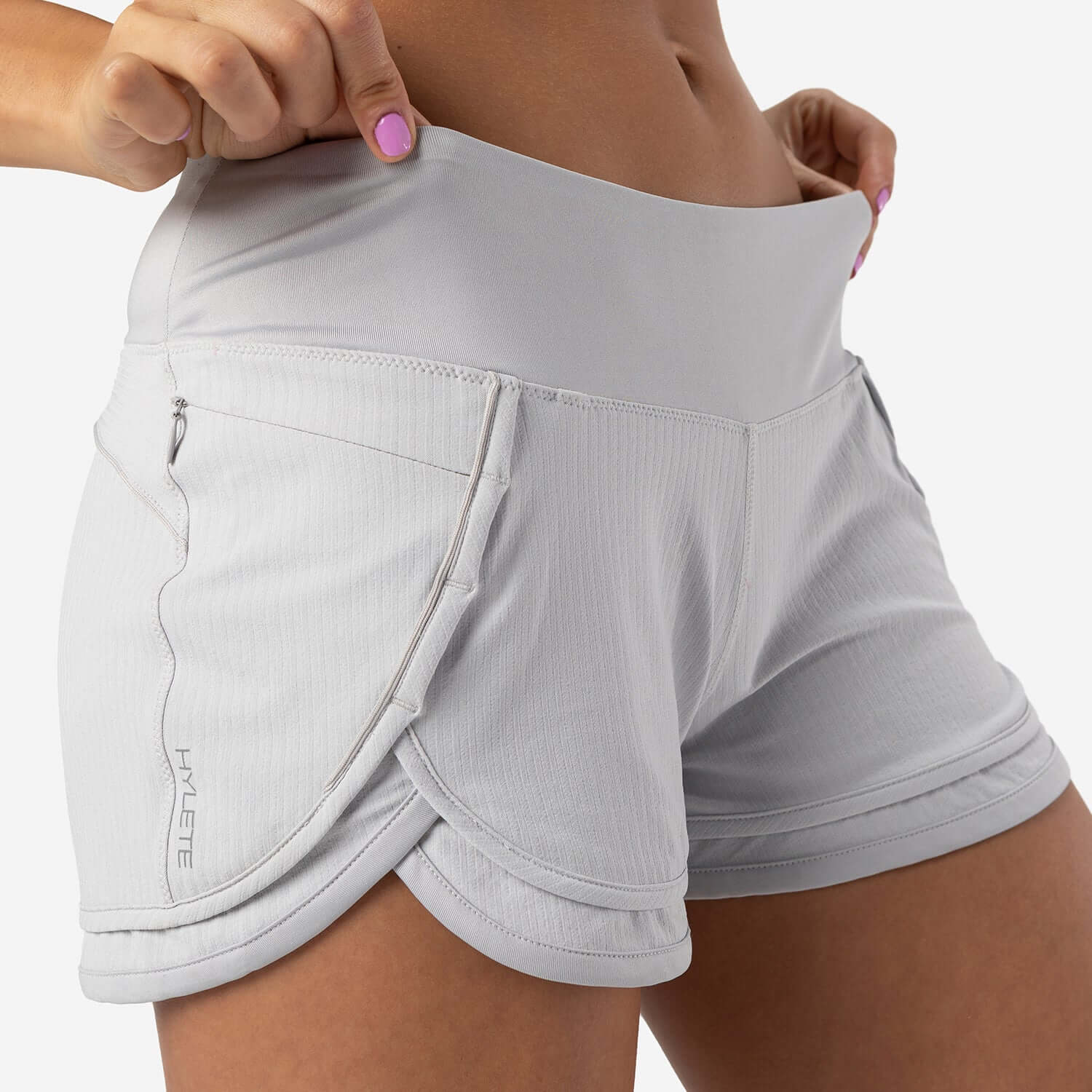 Iris Lined Short Silver featuring a flexible waistband and functional pockets for comfort during workouts.