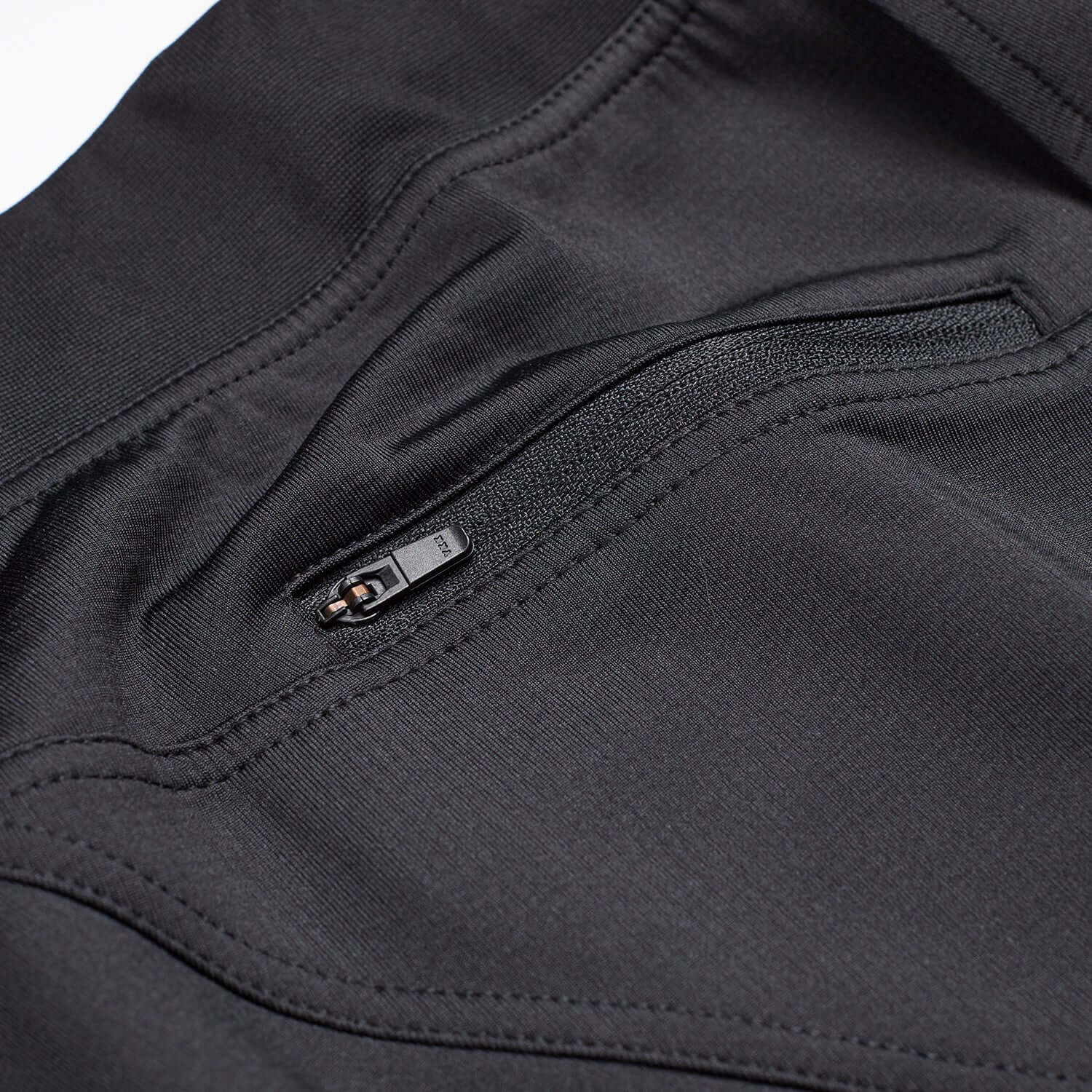 Close-up of Flexion II Jogger Black pocket featuring a secure zipper for added convenience and style.