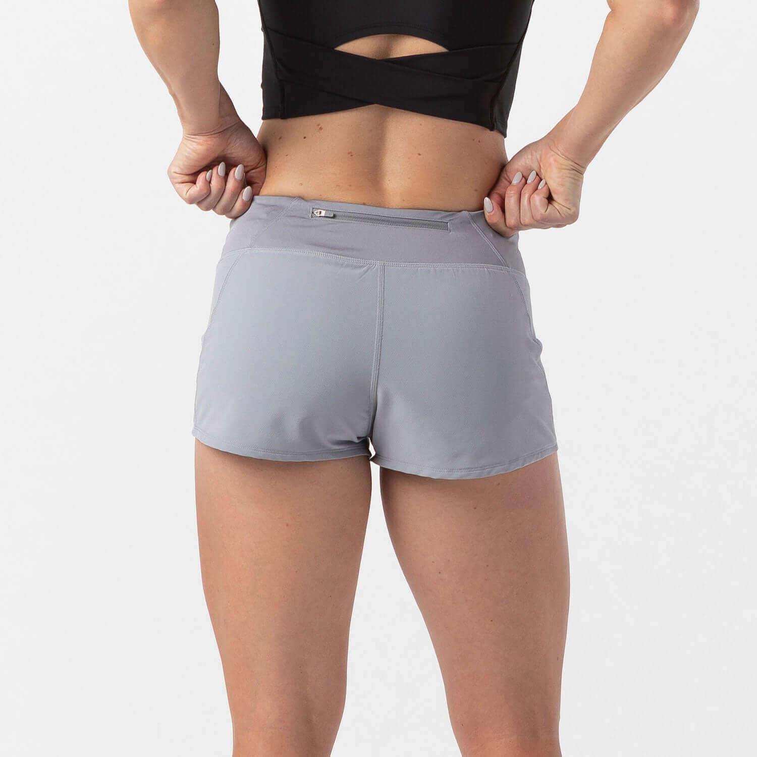 Woman wearing Vita Short Eclipse Gray for running with built-in liner and waistband pocket.