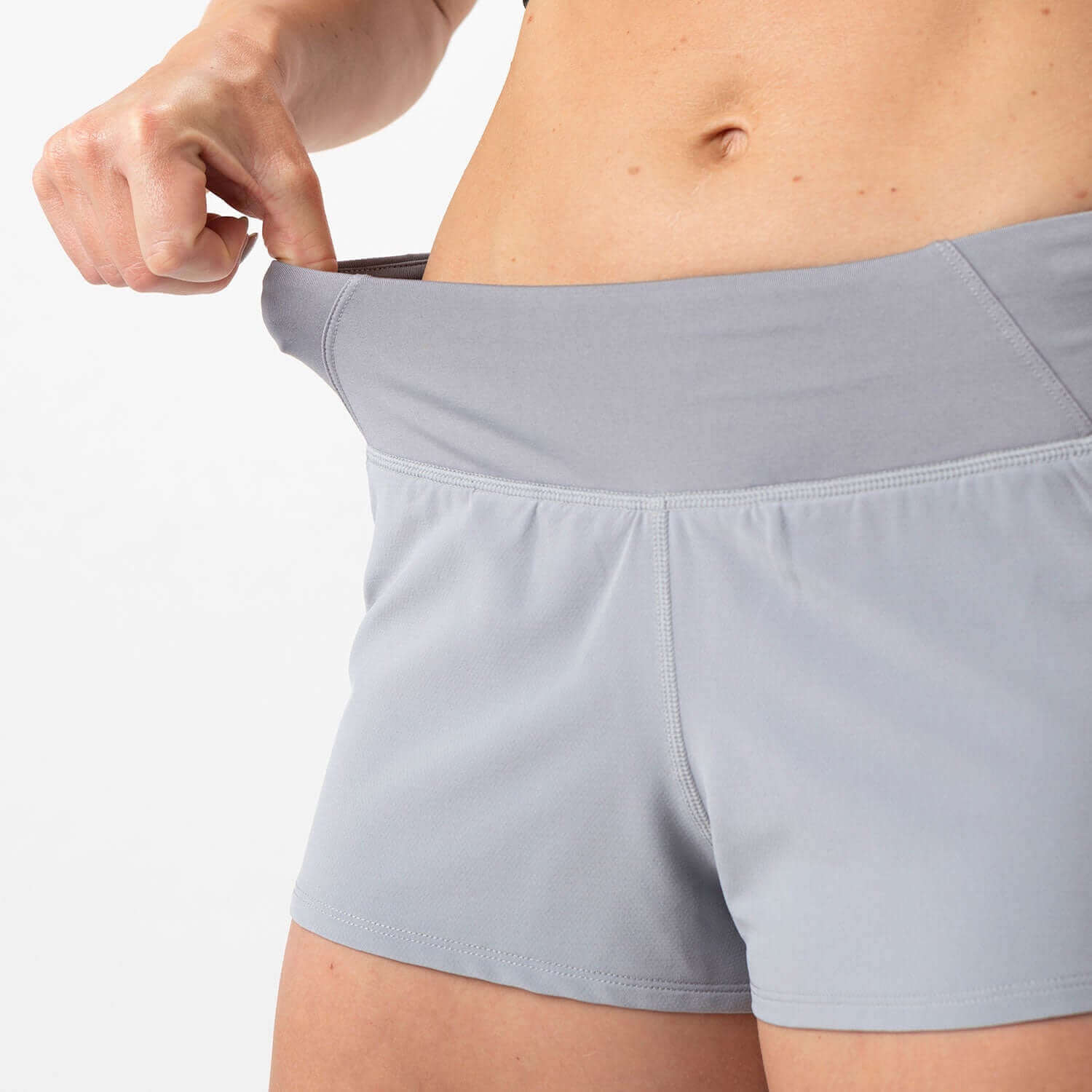 Woman wearing Vita Short Eclipse Gray with smooth-stretch waistband, ideal for runners and HIIT athletes.