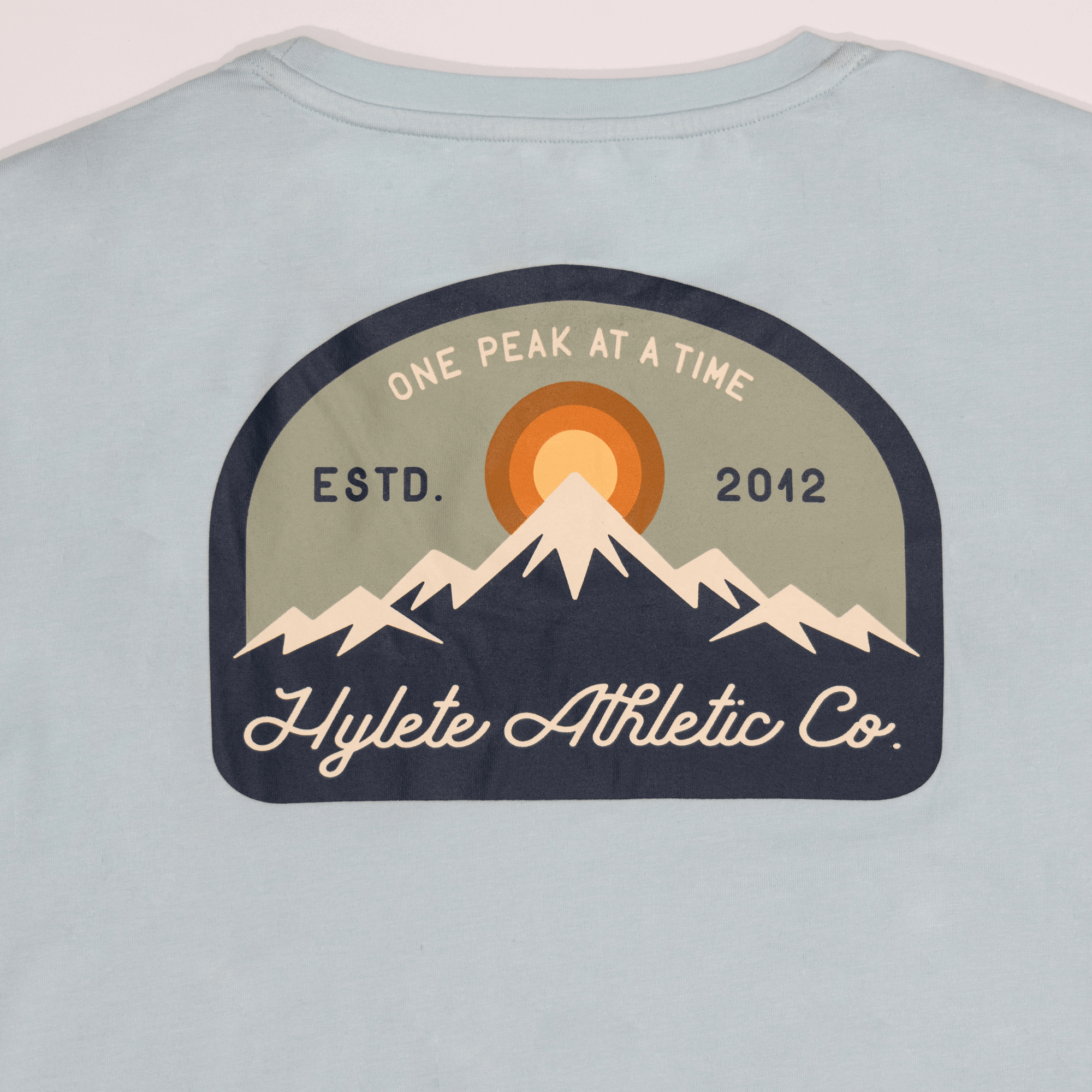 Sky Blue HY-Blend Crew Tee featuring a mountain logo with "One Peak at a Time" and "Hylete Athletic Co. Estd. 2012" text.
