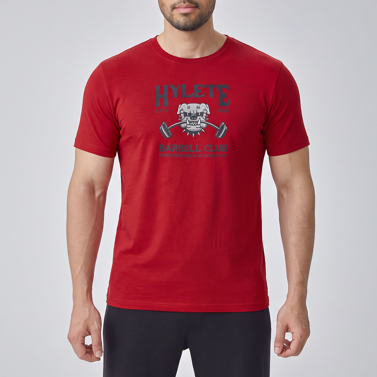 Man wearing a red t-shirt with a logo and text on a light gray background