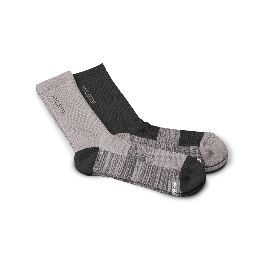 Gray and black midweight crew socks by HYLETE, designed for performance and comfort.