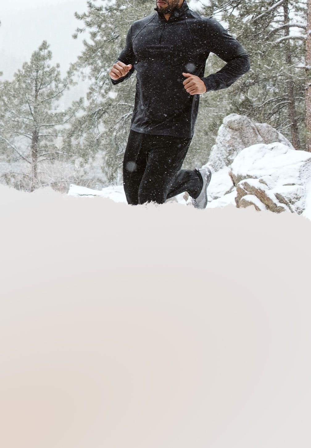 A person running in the snow while wearing a HYLETE Flexion II jacket and ION II pants